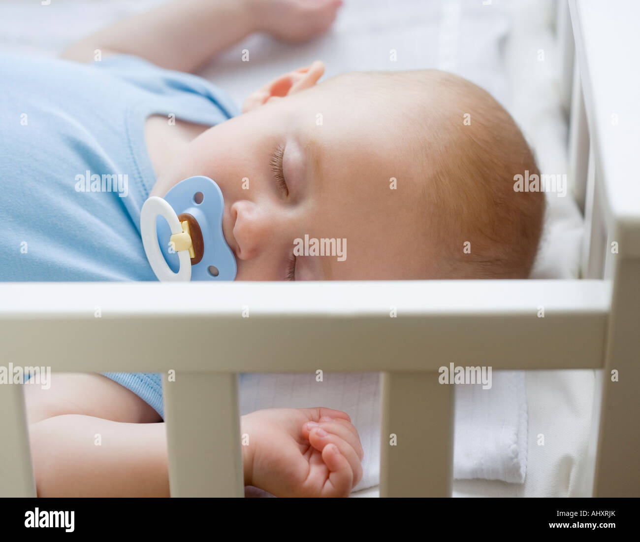 Baby sleeping in crib Stock Photo Alamy
