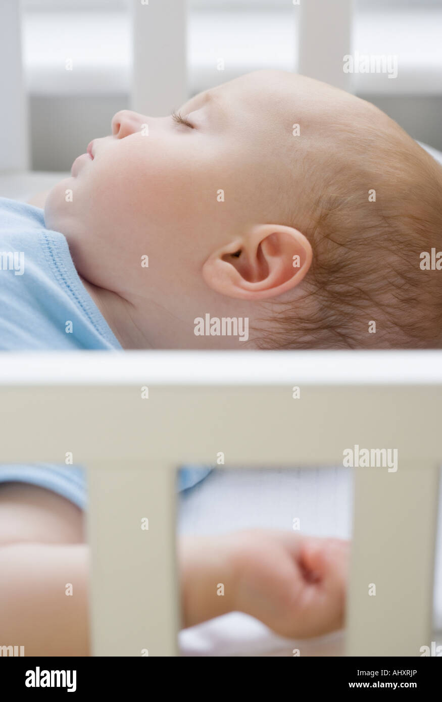 Baby sleeping in crib Stock Photo Alamy