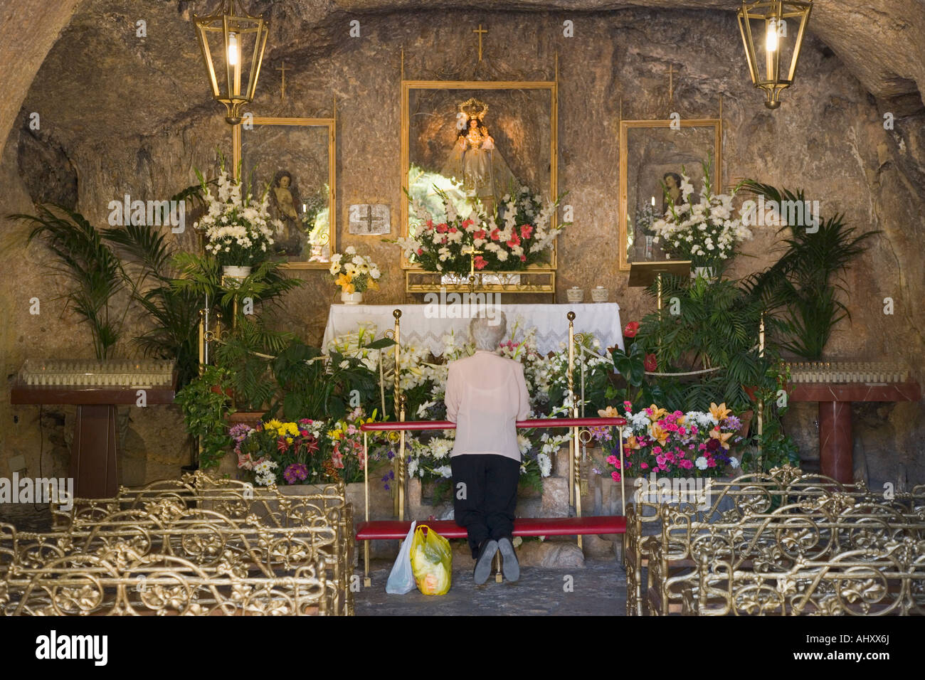 Mijas Malaga Province Costa del Sol Spain Woman praying in La Ermita de la Virgen de la Peña Stock Photo