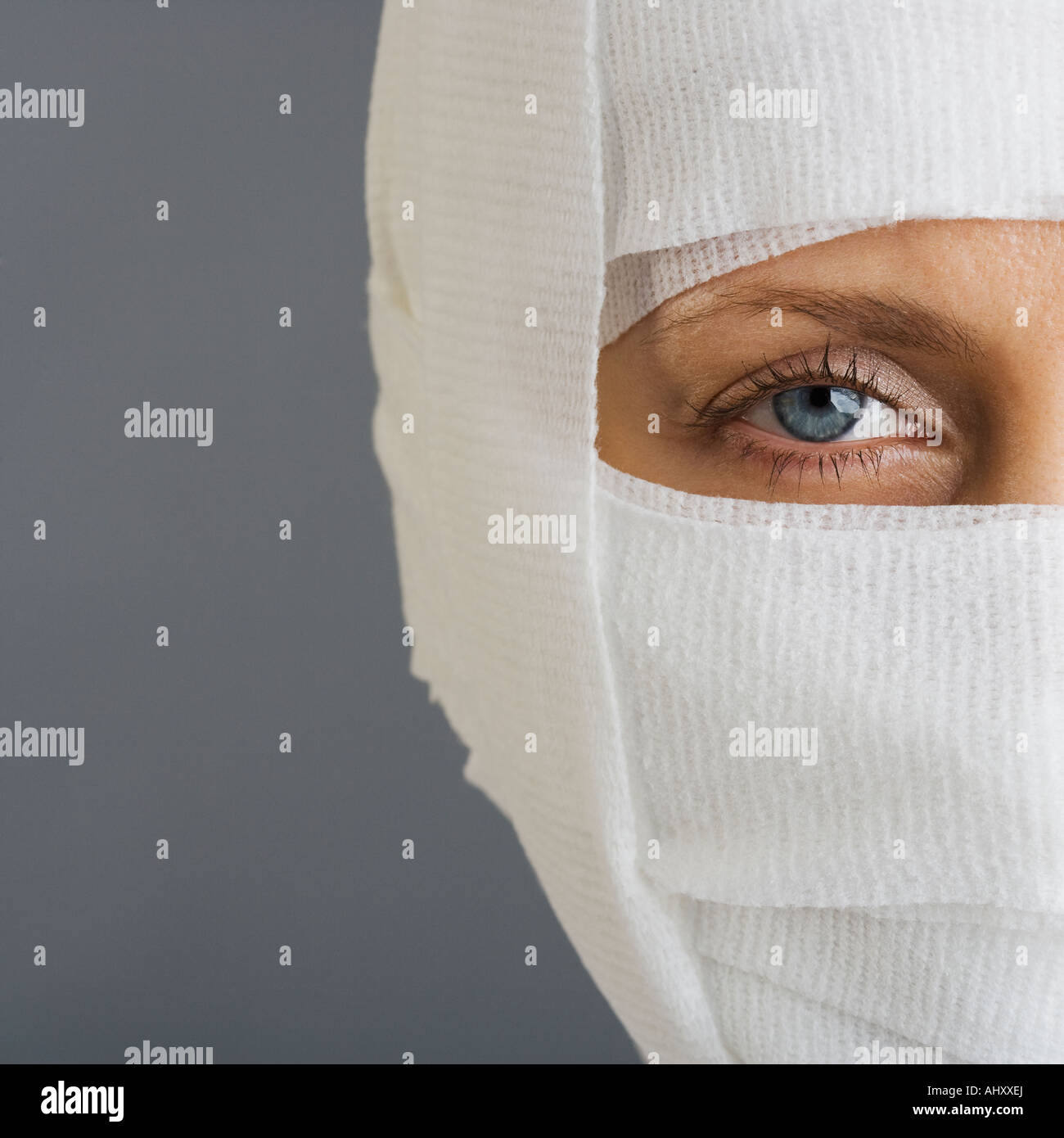 Woman’s face wrapped in bandages Stock Photo