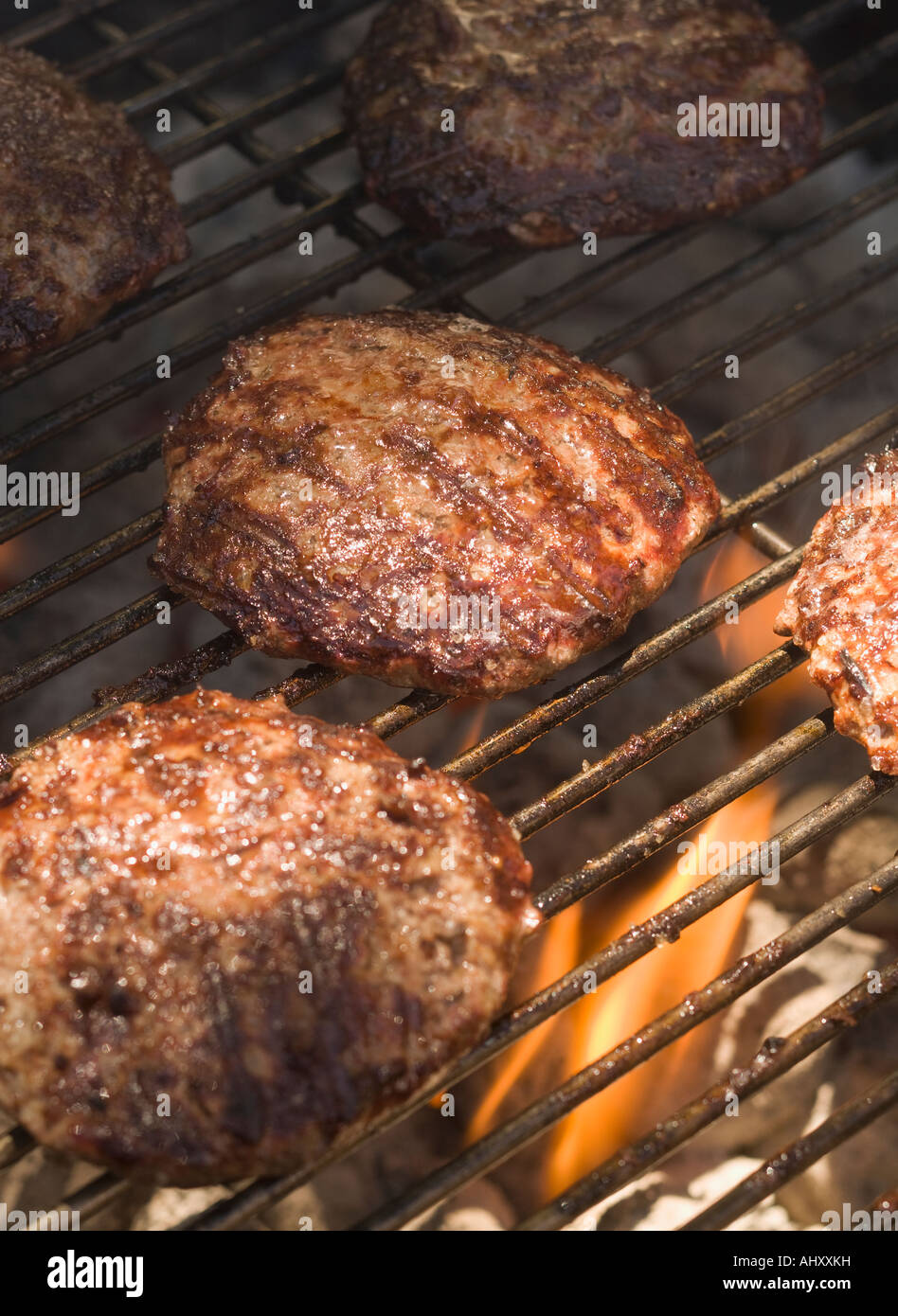 Hamburgers cooking on grill Stock Photo Alamy
