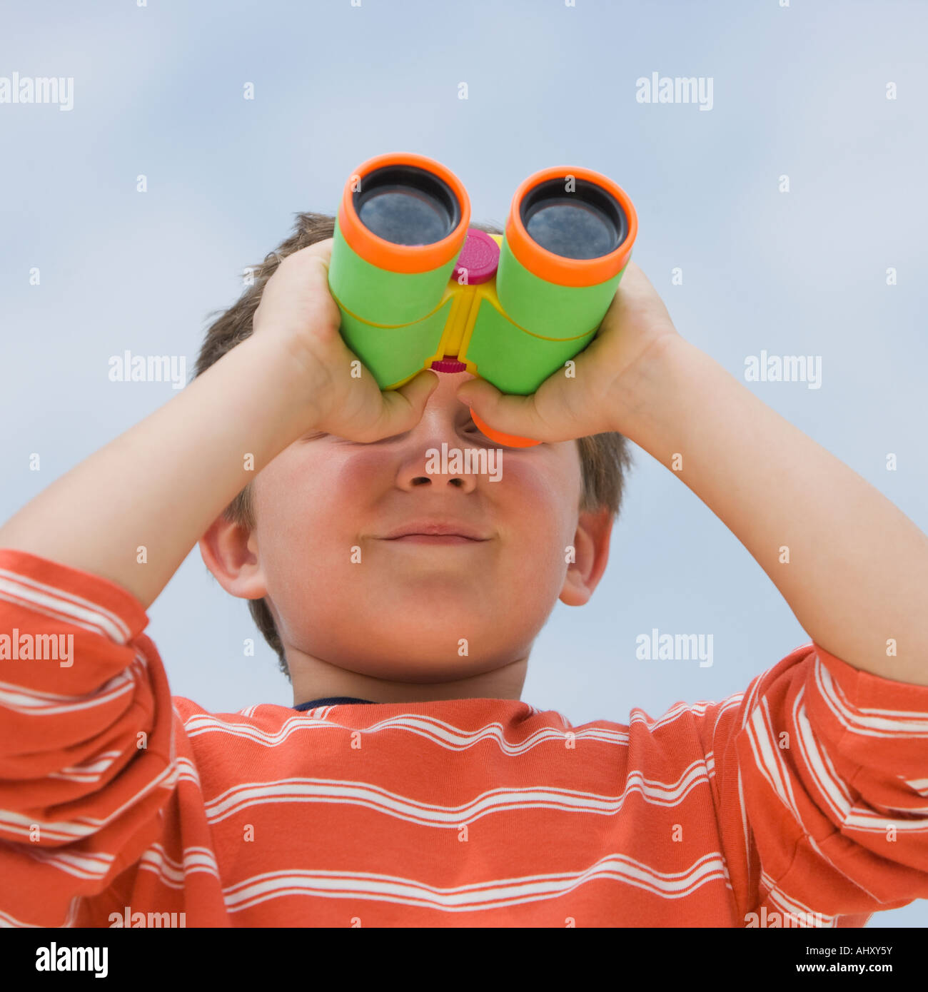 Boy looking through binoculars Stock Photo Alamy