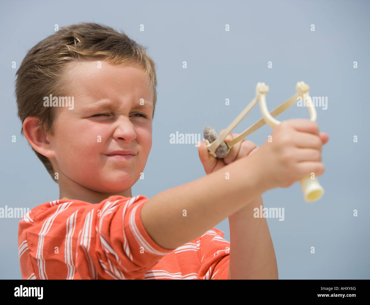 Boy aiming slingshot Stock Photo Alamy