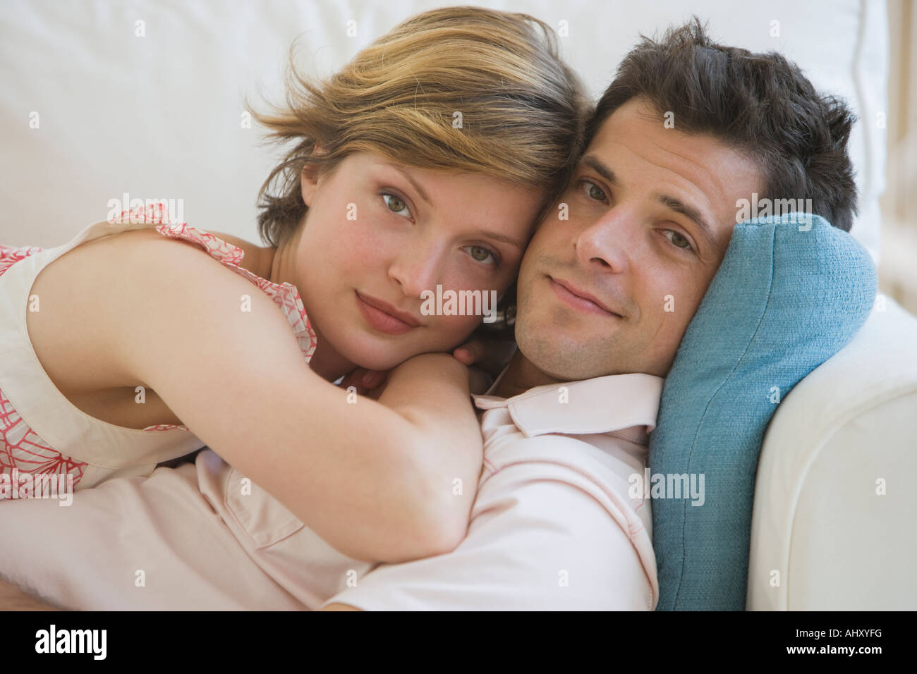Couple hugging on sofa Stock Photo Alamy