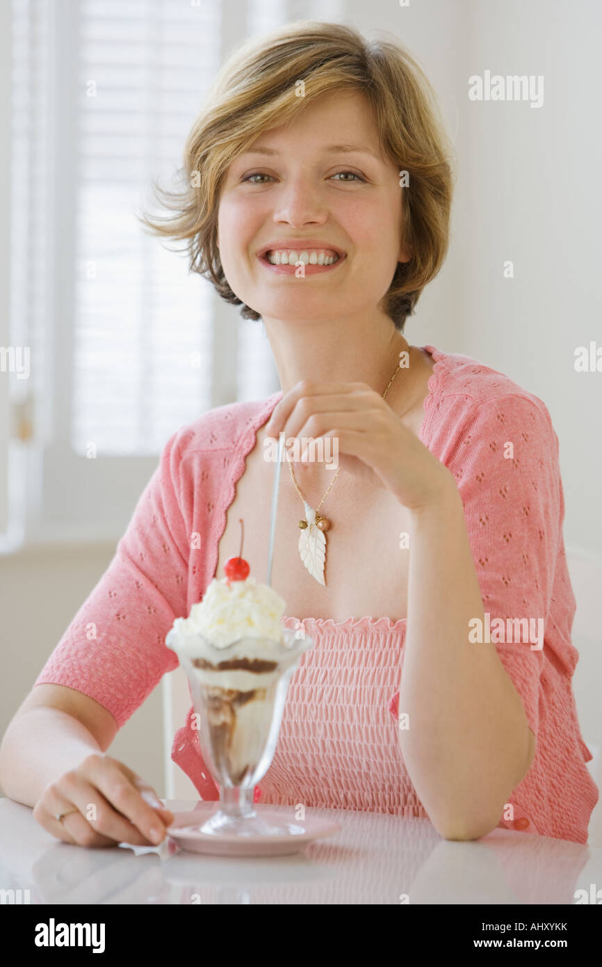 Woman eating ice cream sundae Stock Photo Alamy