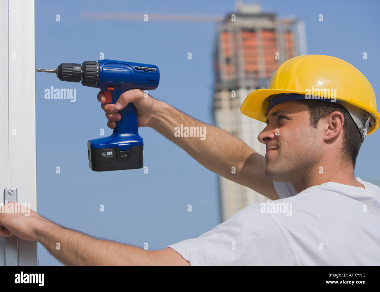 Construction worker using cordless drill Stock Photo Alamy