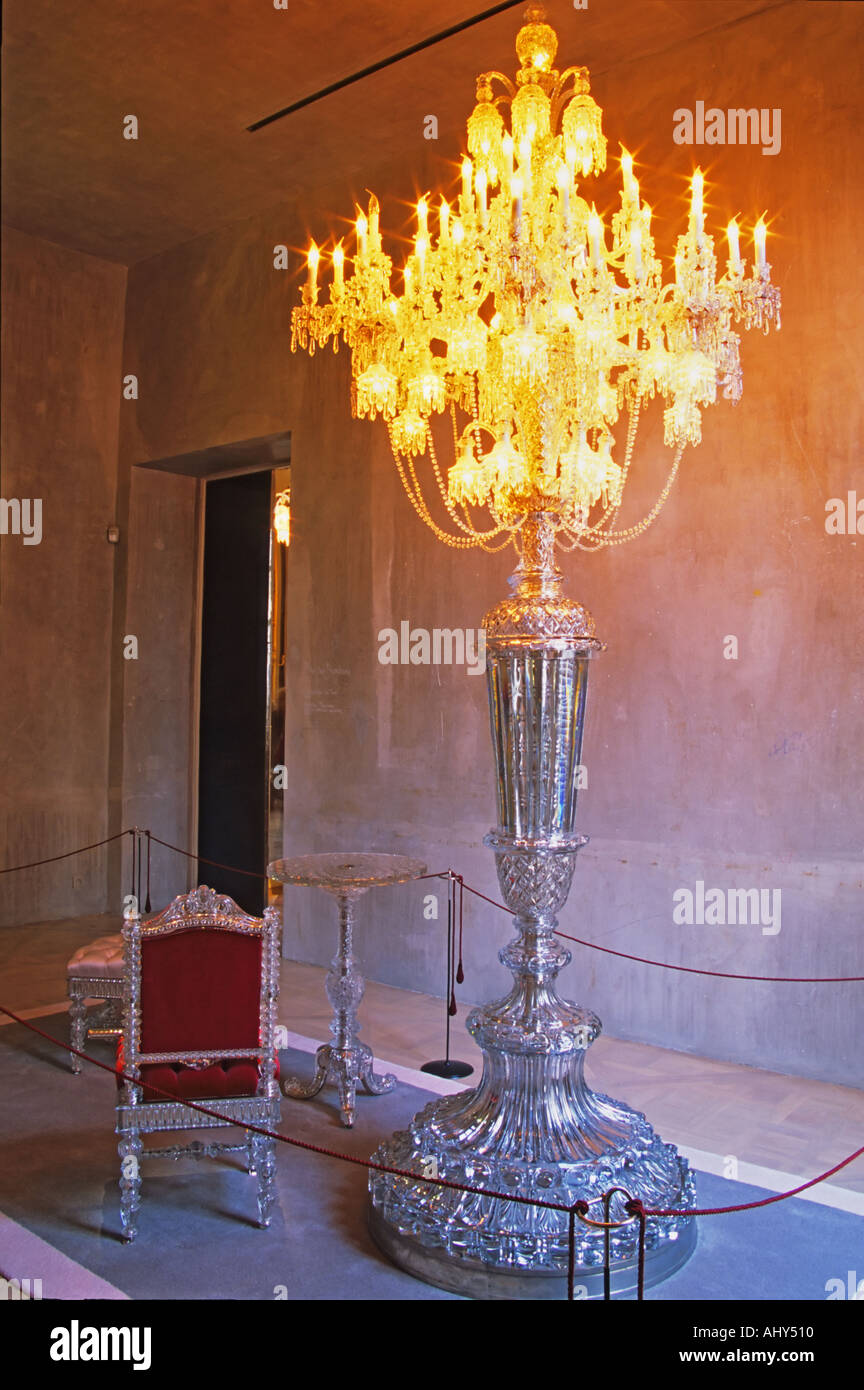 One of the museum piece giant candelabra and crystal chair and table, collector’s item made for maharajas and sheiks, in plush red velvet. At The Baccarat museum, shop, restaurant at the Hotel de Noailles in Paris. Designed by Philippe Starck. Stock Photo