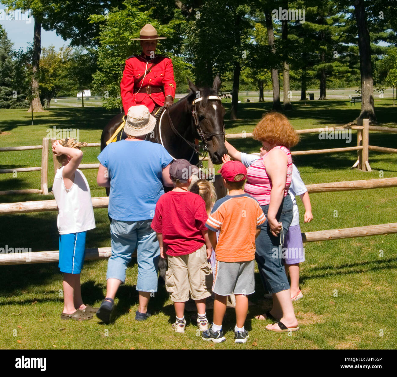 A group of people talking to a mountie at the RCMP (Royal Canadian Mounted Police) Musical Ride centre in Ottawa, Ontario Canada Stock Photo