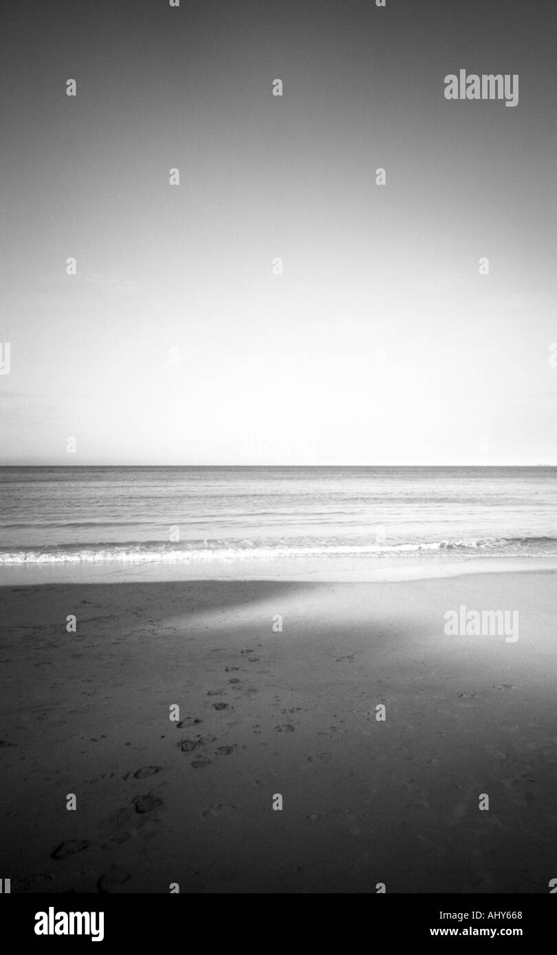 black and white shot looking out to sea sun shinning across taken in ...