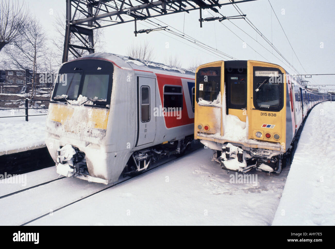 Two snowy computer trains at Shenfield railway station platforms  shortly after snowstorm waiting to travel to London Liverpool Street England UK Stock Photo