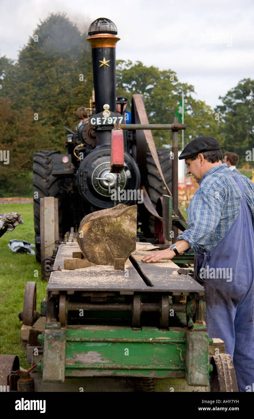 Man operating a steam powered wood saw Stock Photo