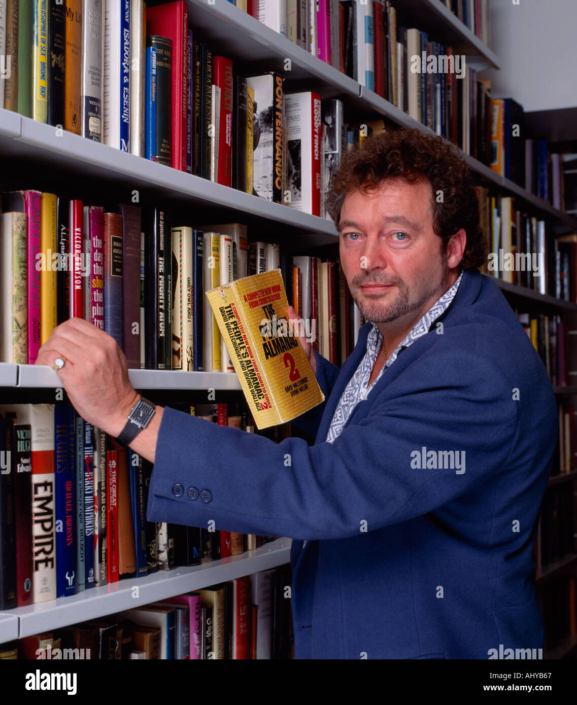 The late prankster Jeremy Beadle in his library in London in England in Great Britain in the United Kingdom. Fame Famous Stock Photo
