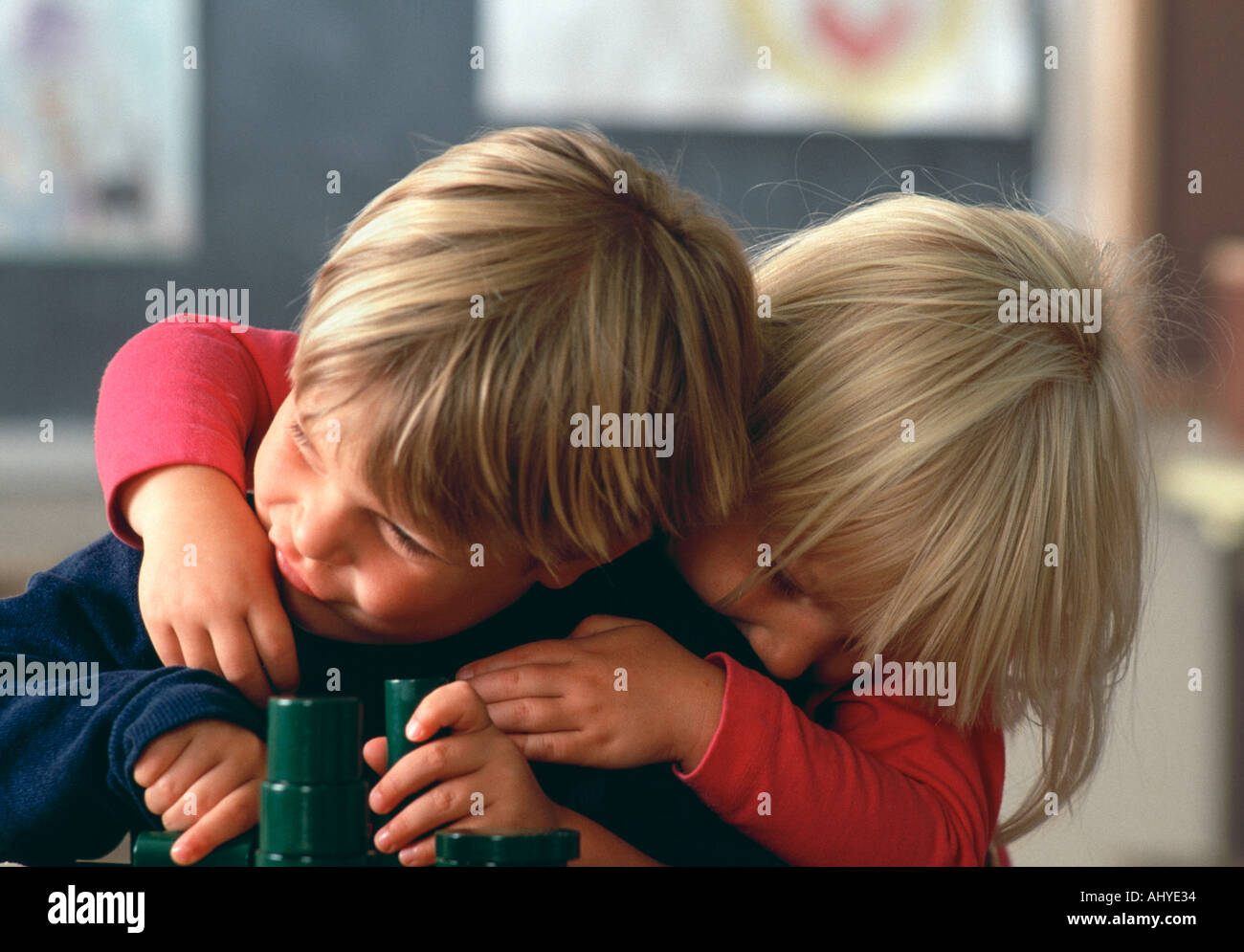 Hyperactive Caucasian preschool students Playing and wrestling in their kindergarten class Stock Photo