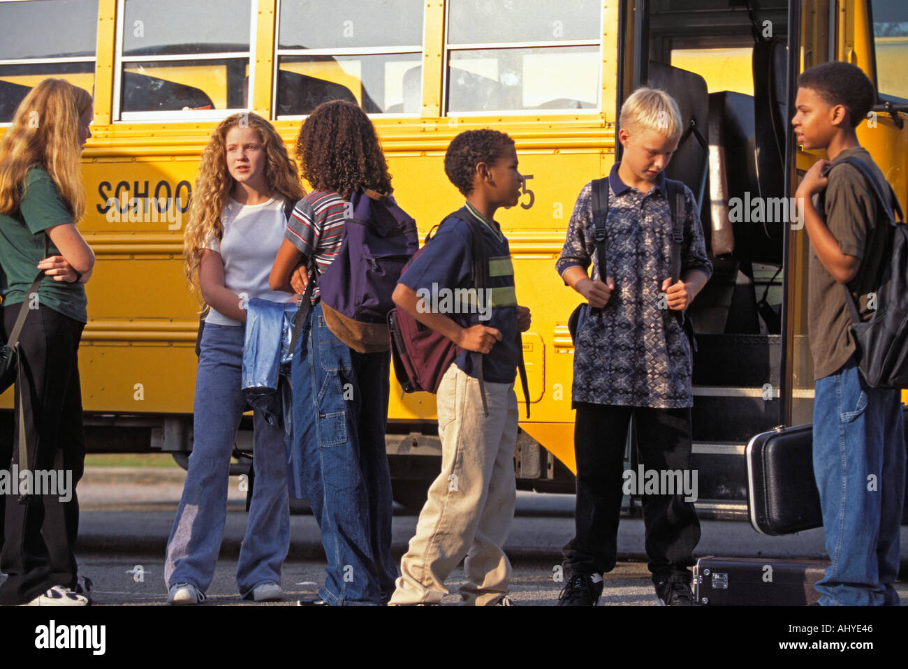 Caucasian And African American Teenage Middle School Students Getting