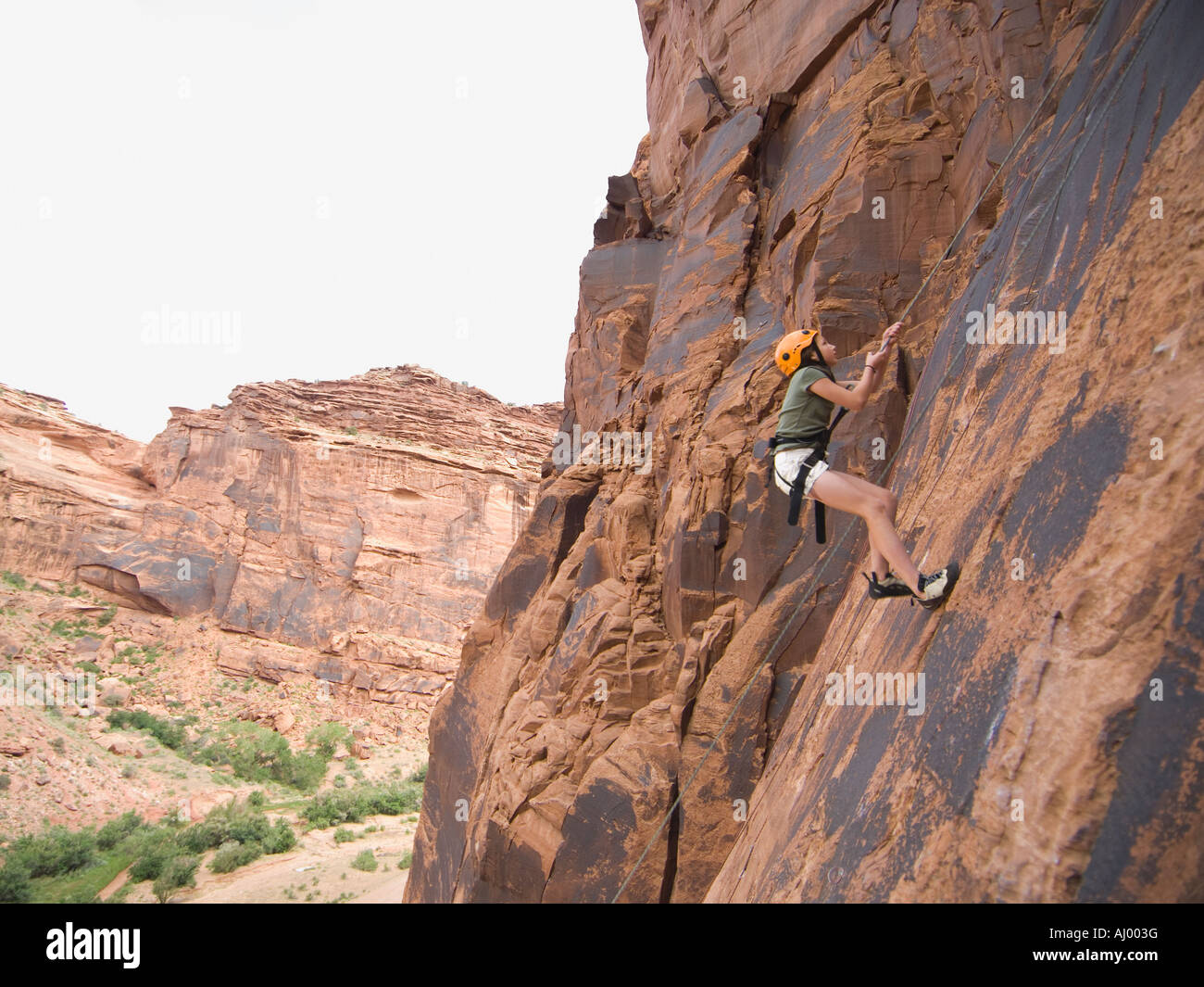 Woman rock climbing Stock Photo - Alamy