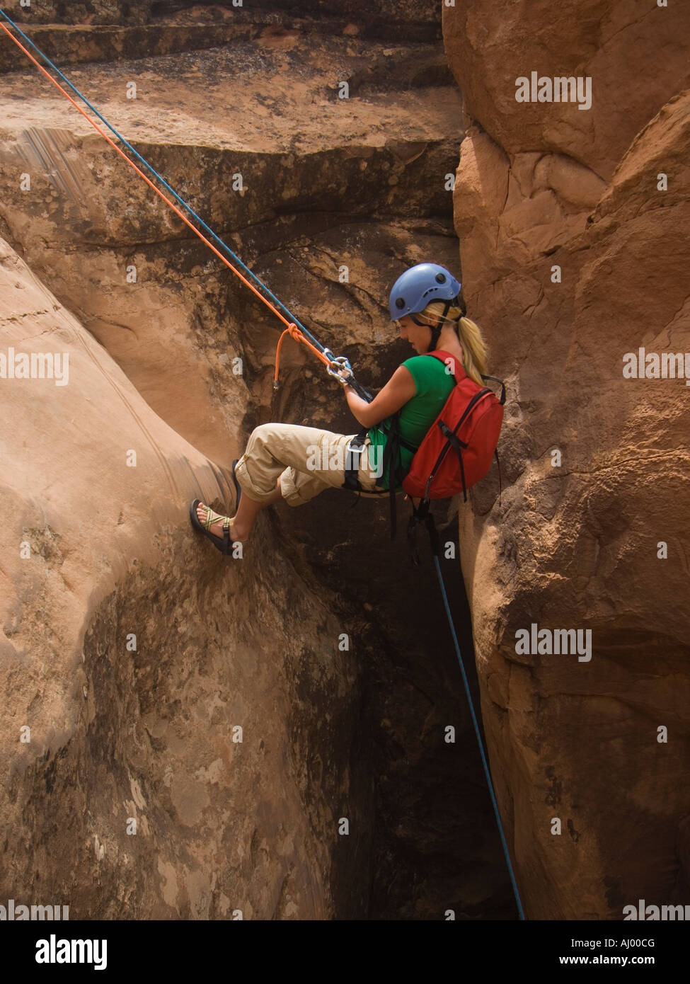 Woman canyon rappelling Stock Photo - Alamy