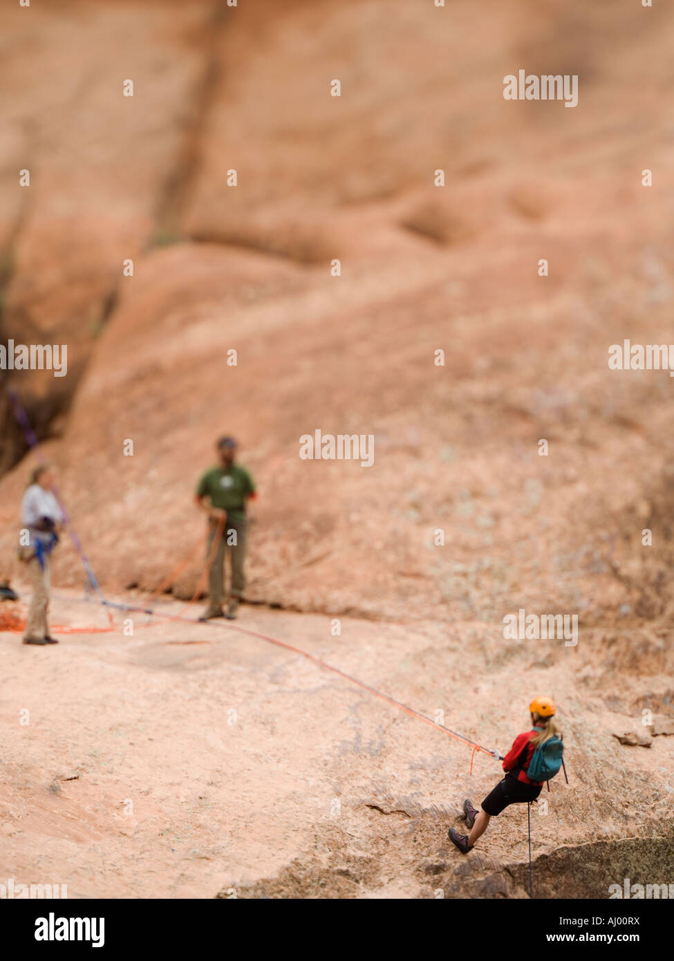 Woman in rappelling gear at top of cliff Stock Photo Alamy