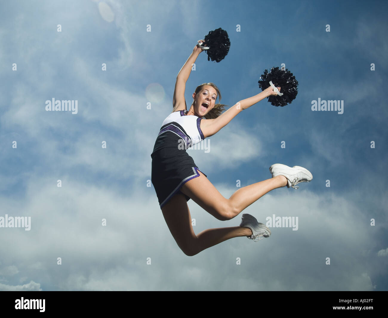 Cheerleader Jumping with Pom-Poms Stock Photo - Image of energy