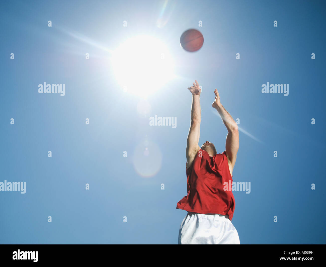 Man shooting basketball Stock Photo - Alamy