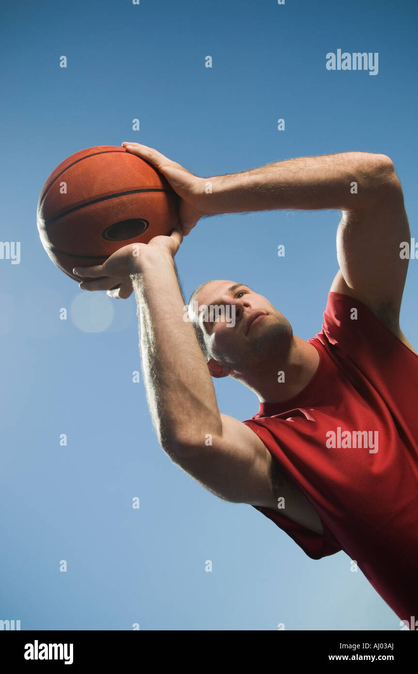 Man shooting basketball Stock Photo - Alamy