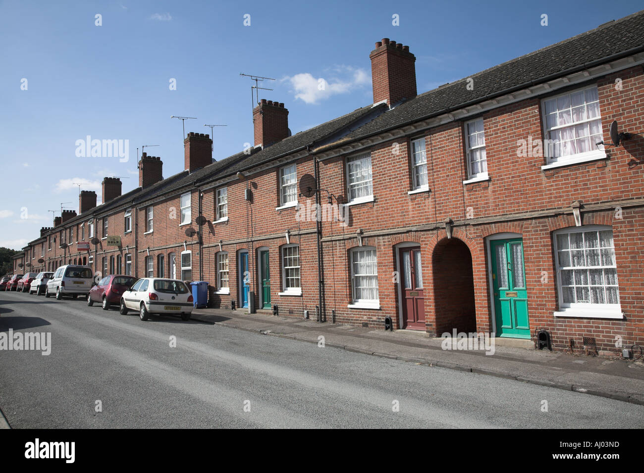 Row of terraced red brick houses windows Ipswich Suffolk England Stock Photo