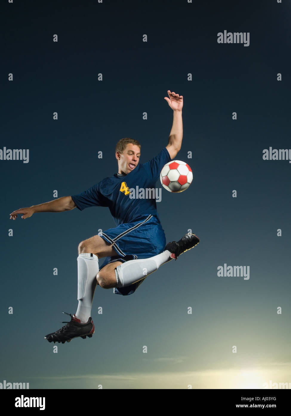 Man kicking soccer ball in air Stock Photo Alamy