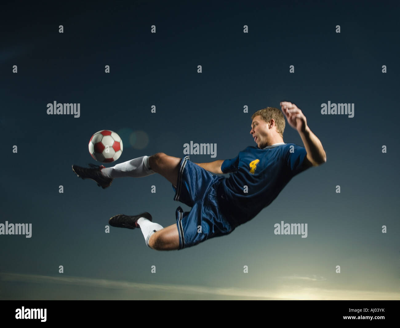 Man kicking soccer ball in air Stock Photo Alamy