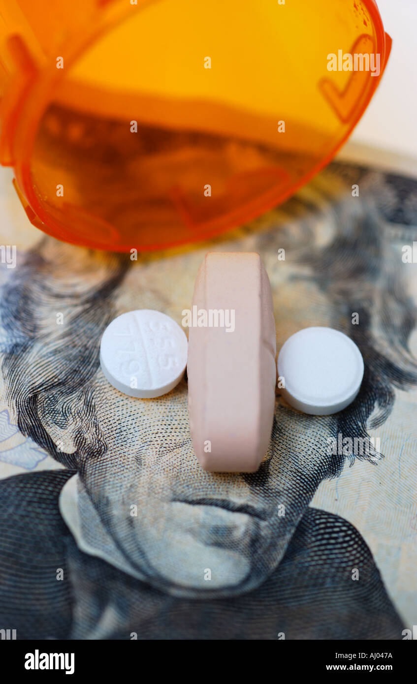 Three pills spilled on 20 dollar bill Stock Photo