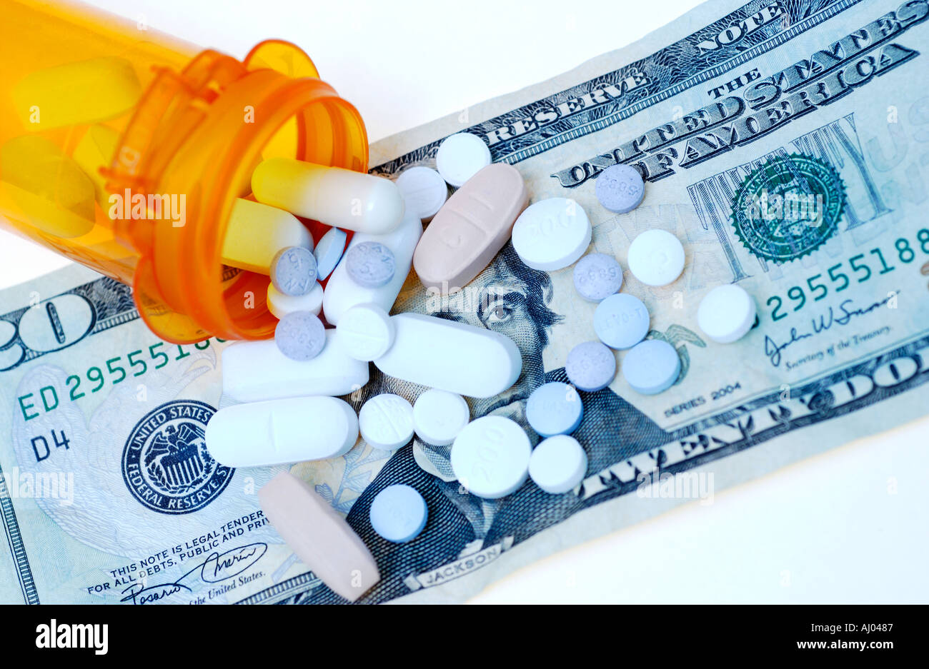 Pills spilled on 20 dollar bill Stock Photo