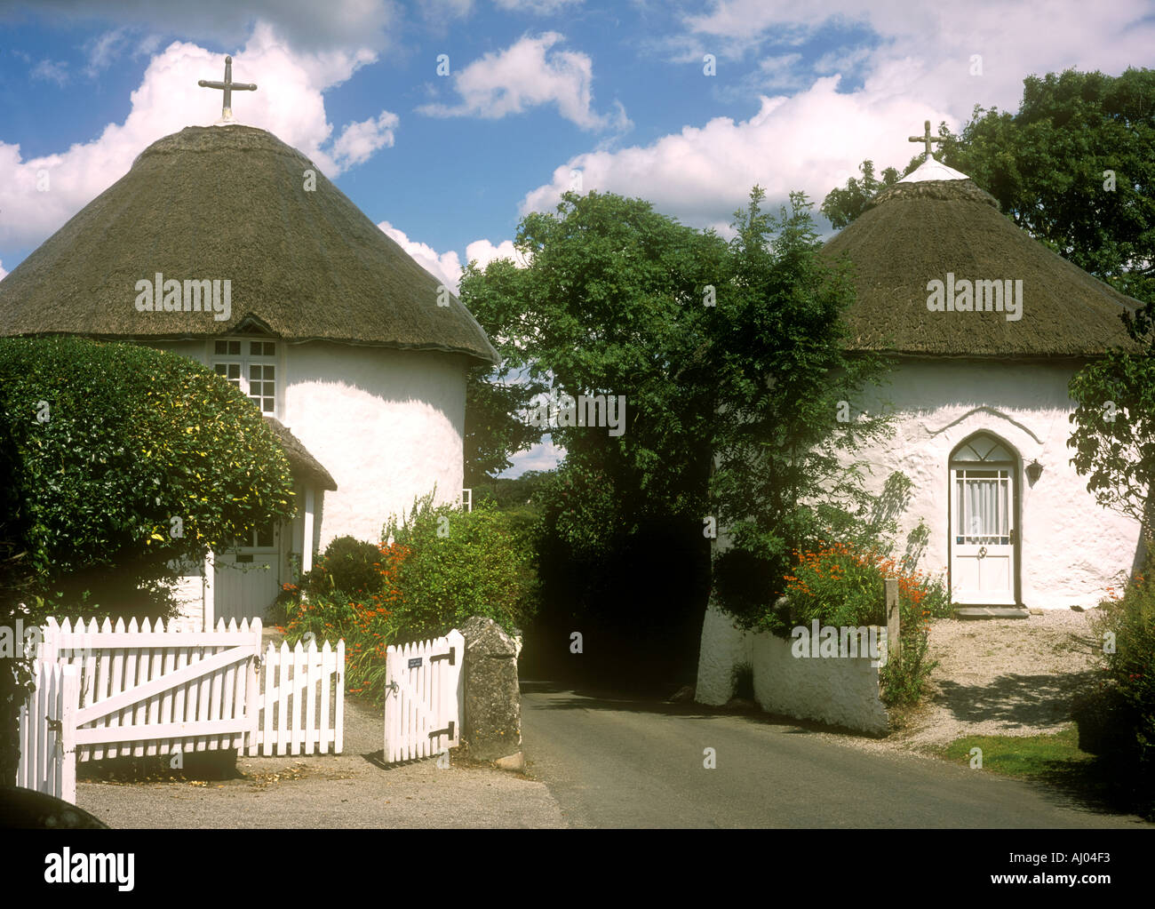 The famous thatched round houses in the village of Veryan on the Roseland Peninsula in Cornwall in the UK Stock Photo