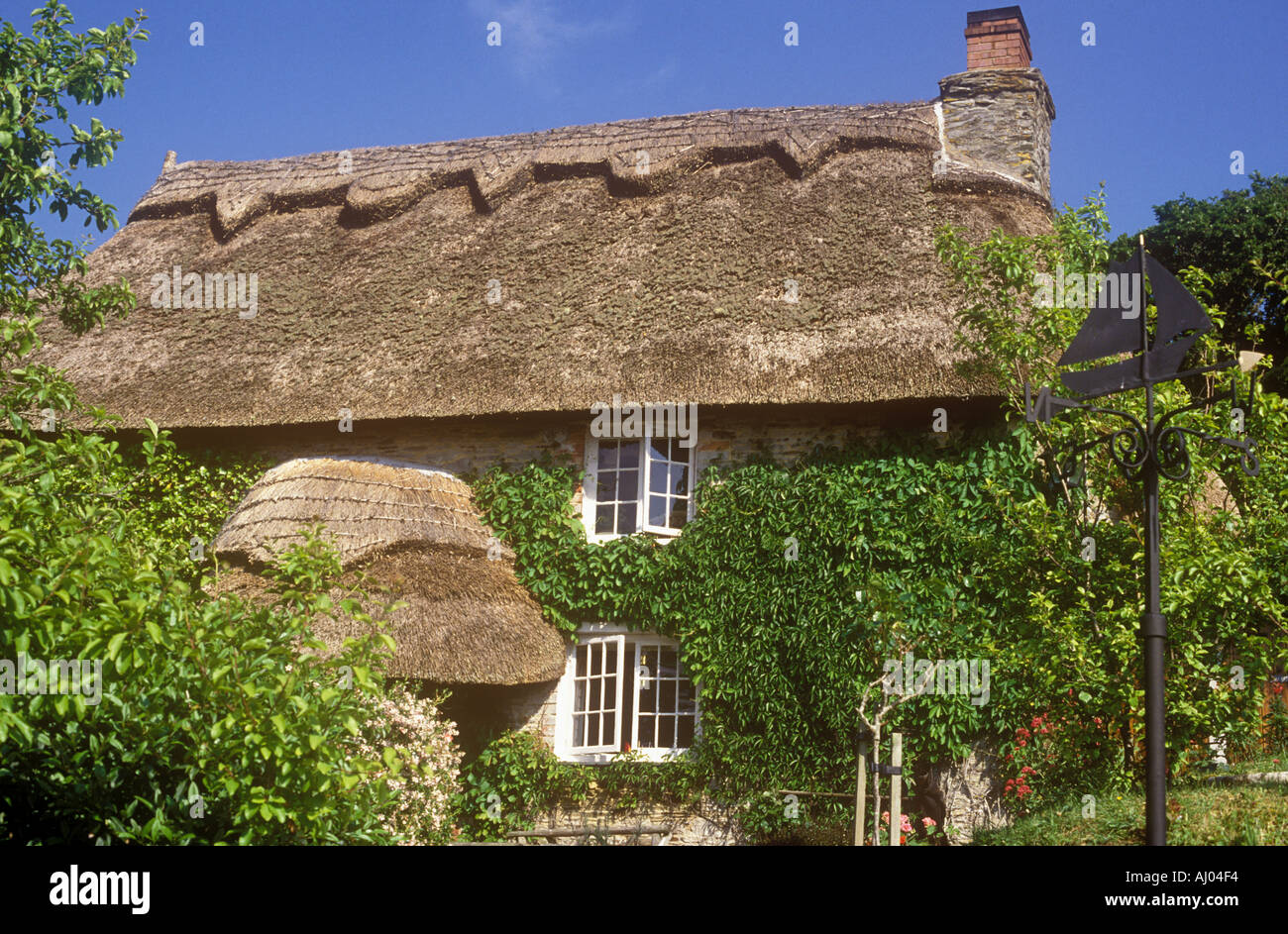 Thatched cottage called Smugglers Cottage built of stone - vernacular style, at Tolverne on the Roseland Peninsula in Cornwall in the United Kingdom Stock Photo