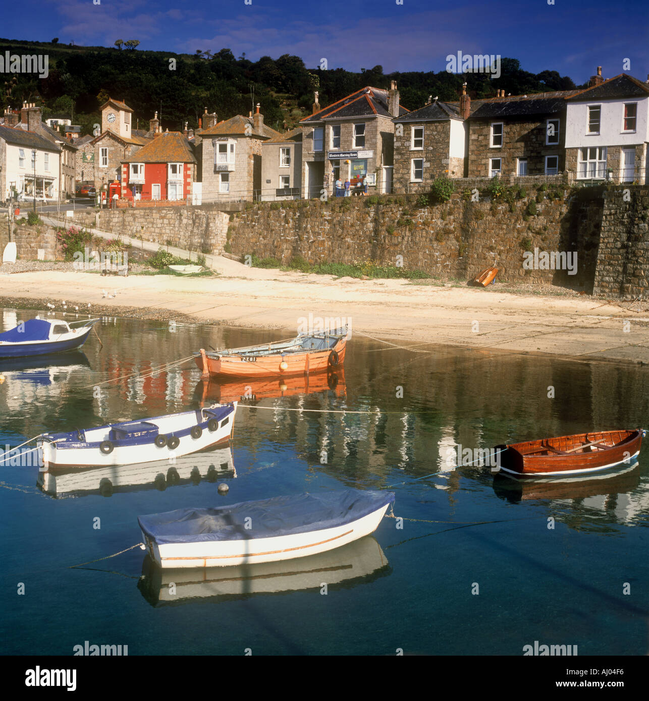 Fishing boats moored in the harbour at Mousehole village near Penzance in West Cornwall in the UK Stock Photo