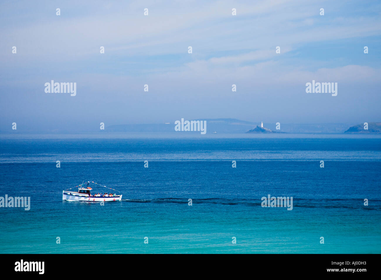 Small fishing boat pleasure craft in turquoise sea off St Ives in summer sunshine Atlantic Ocean Cornwall England UK GB Stock Photo