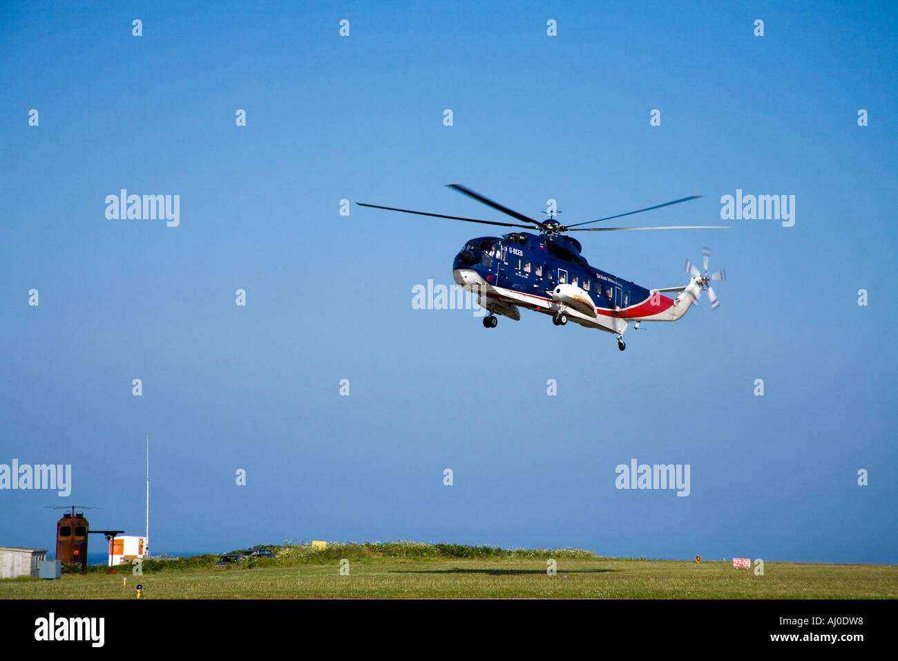 Helicopter landing at St Marys Airport on the Isles Of Scilly Cornwall England UK United Kingdom GB Great Britain British Isles Stock Photo