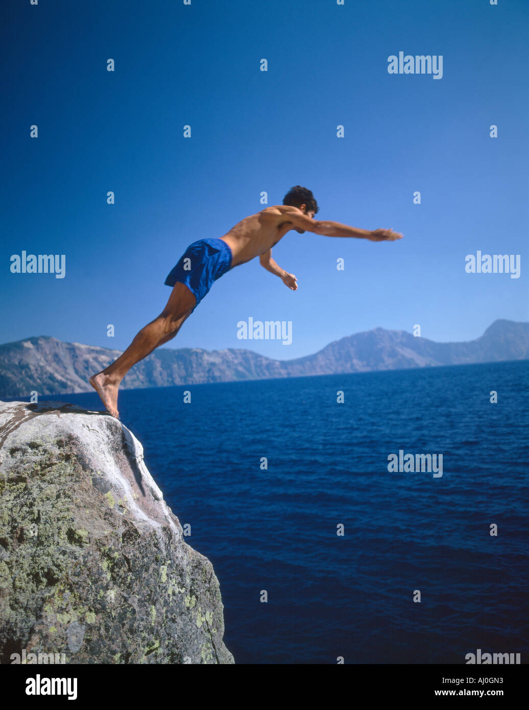 Man diving into Crater Lake Oregon Stock Photo Alamy