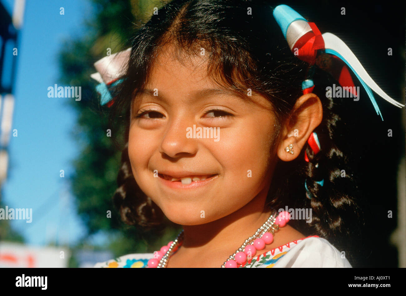 A Mexican American Girl With Ribbons In Her Hair Stock Photo Alamy