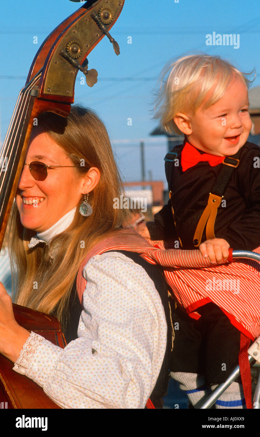 A mother playing the standup bass with her young son Hannibal MO Stock Photo