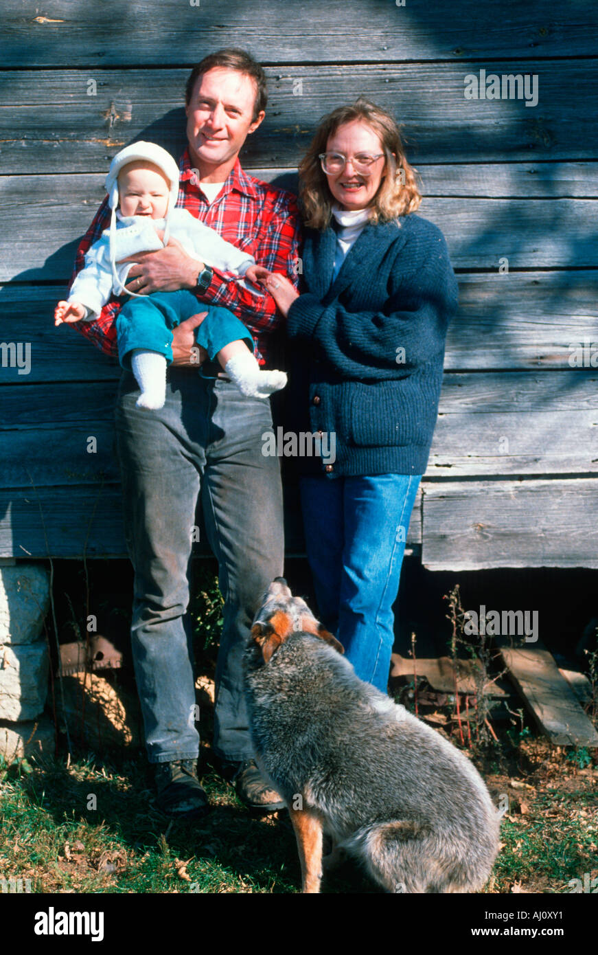 Parents and their baby on the family farm Bourbon MO Stock Photo