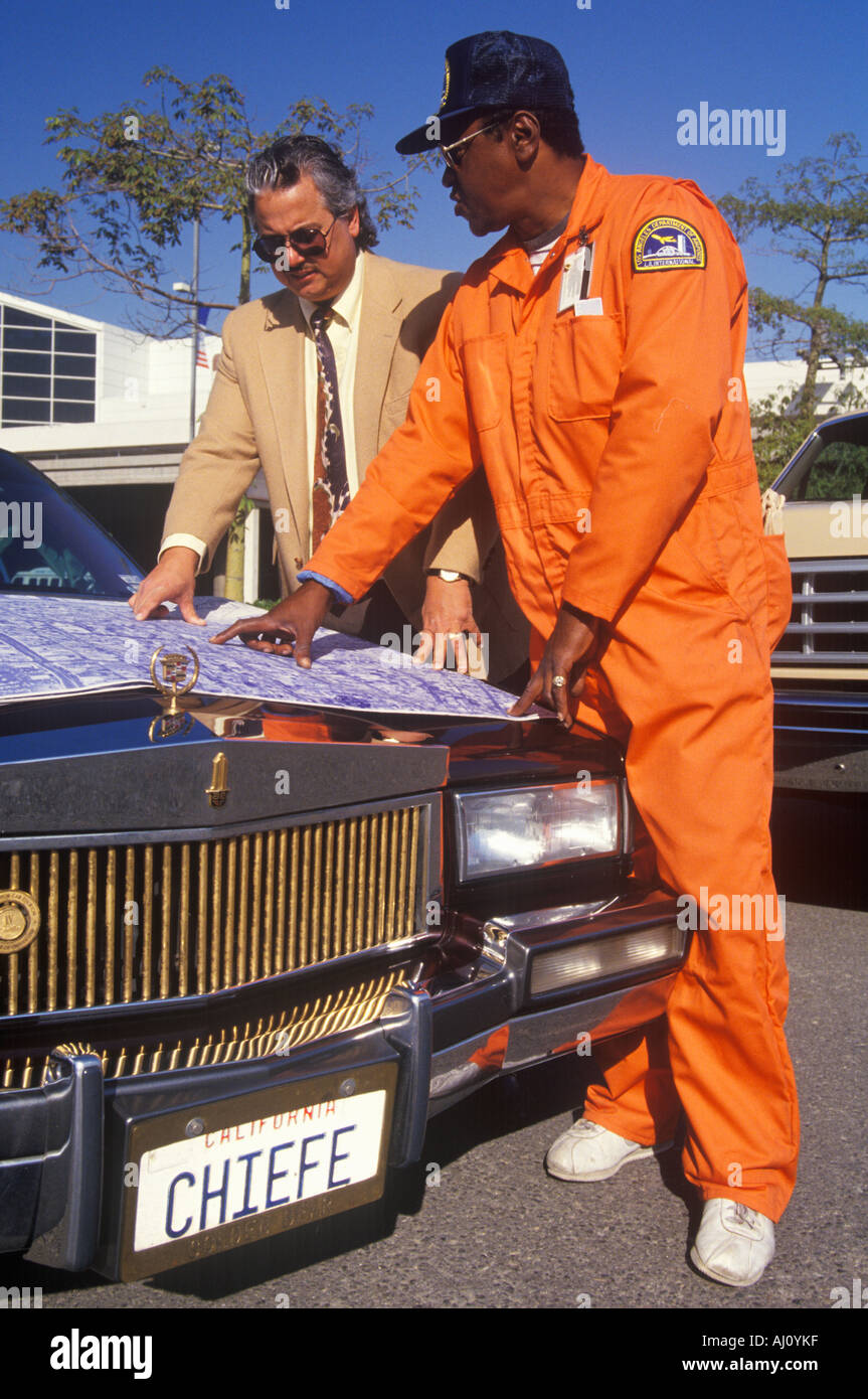 An architect reviewing the building plans with his foreman Stock Photo