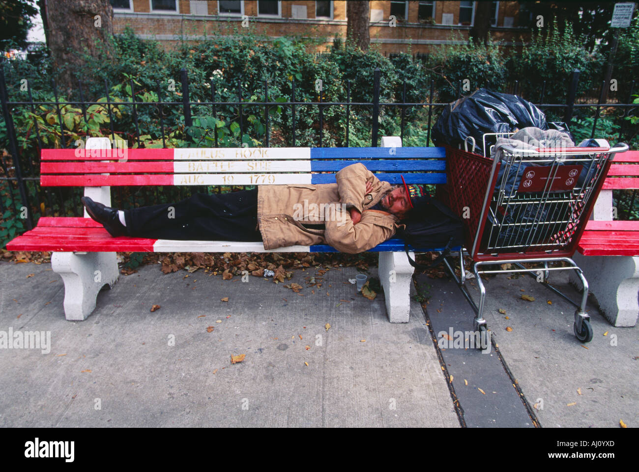 A Homeless Man Sleeping On A Park Bench Jersey City New Jersey