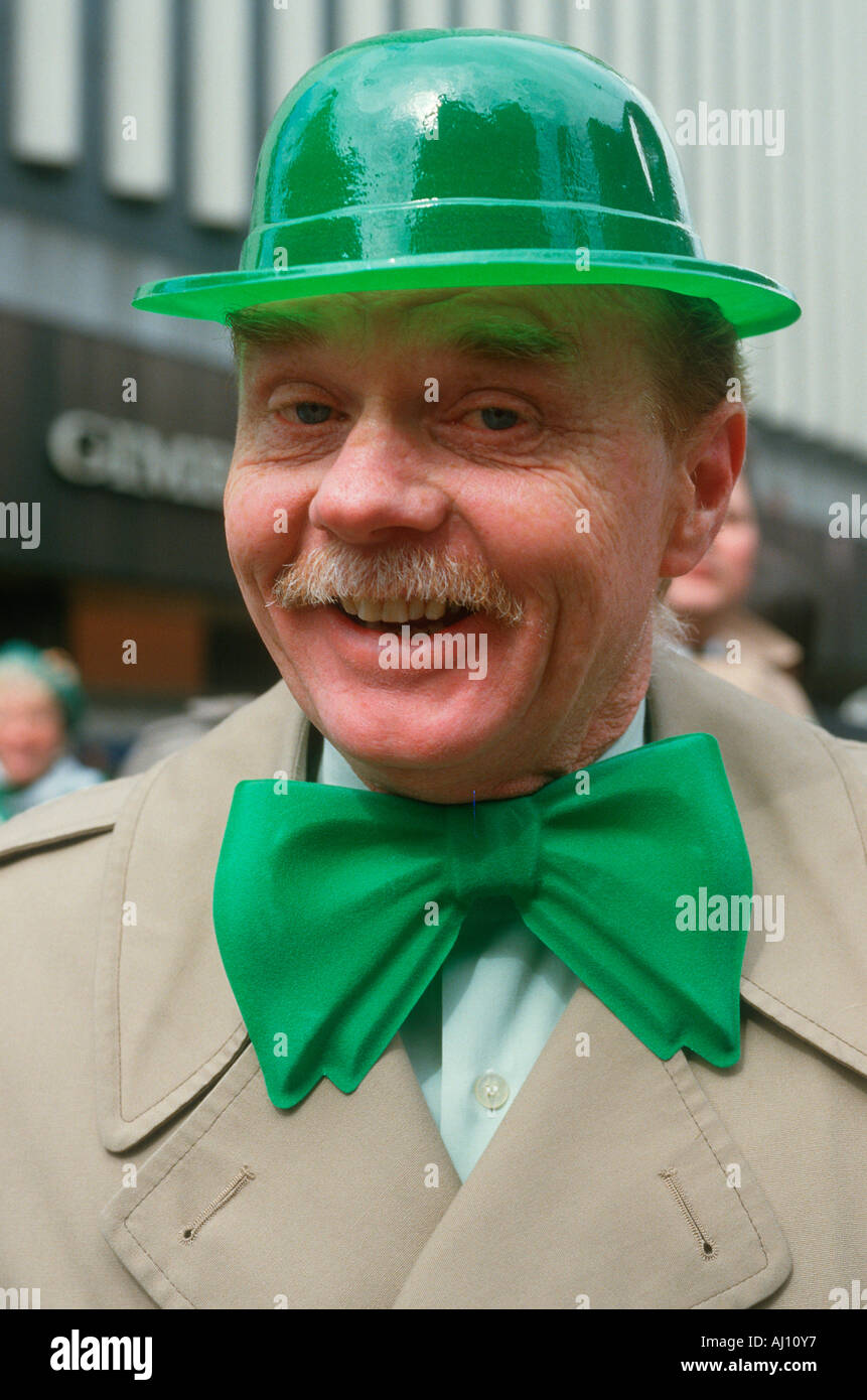 A man dressed in green derby and bow tie for the St Patrick s Day Parade NY City Stock Photo
