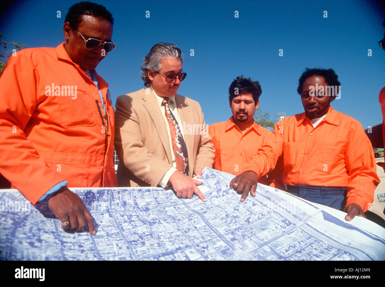An architect reviewing the building plans with his crew Stock Photo