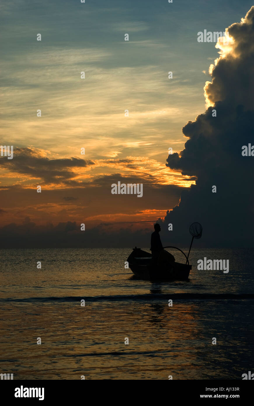 Silhouette of a fisherman Stock Photo - Alamy