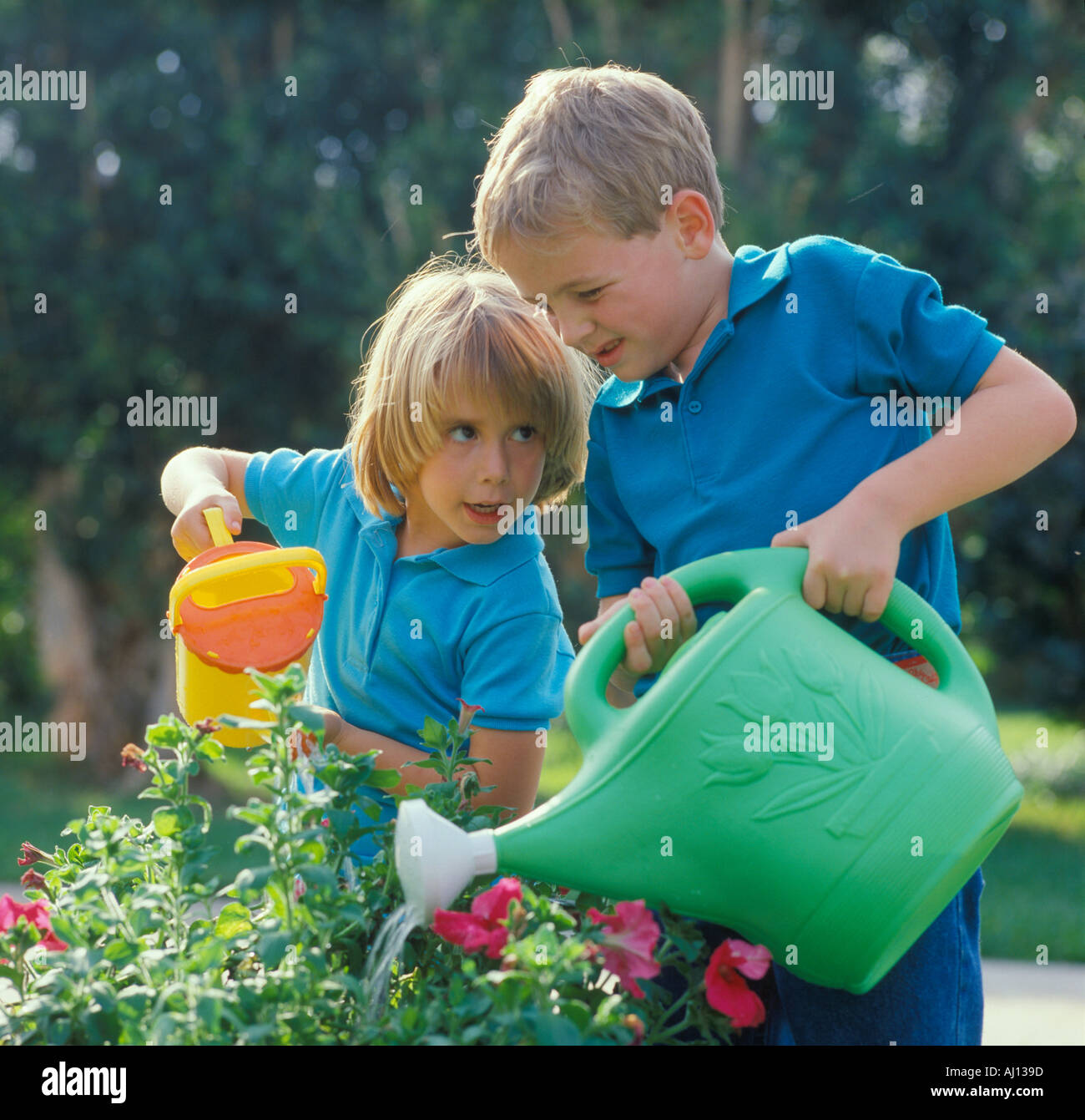 Girl and boy watering plants hi-res stock photography and images - Alamy