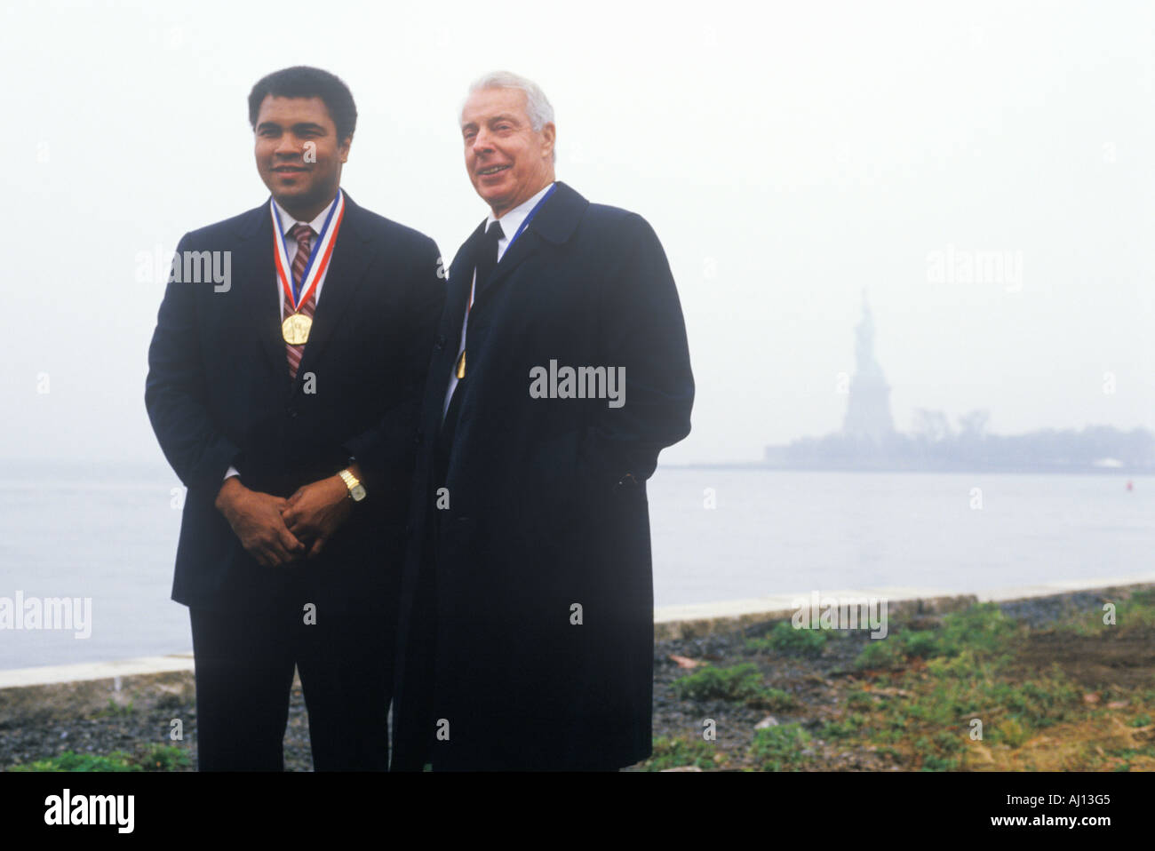 Muhammed Ali and Joe DiMaggio wearing gold medals Ellis Island NY Stock Photo