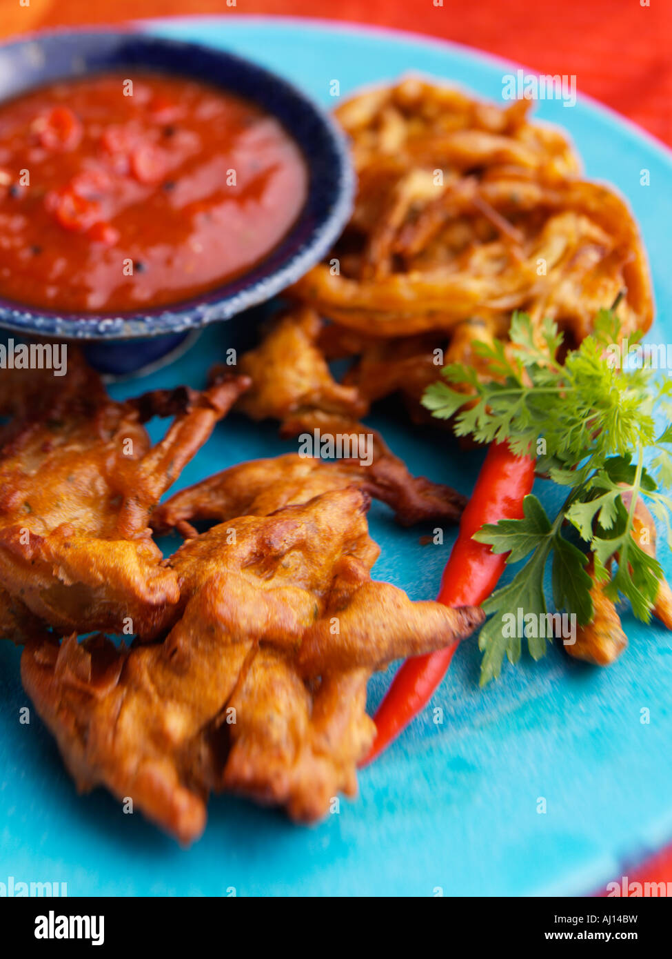 Indian onion bhajis with a dipping sauce Stock Photo Alamy