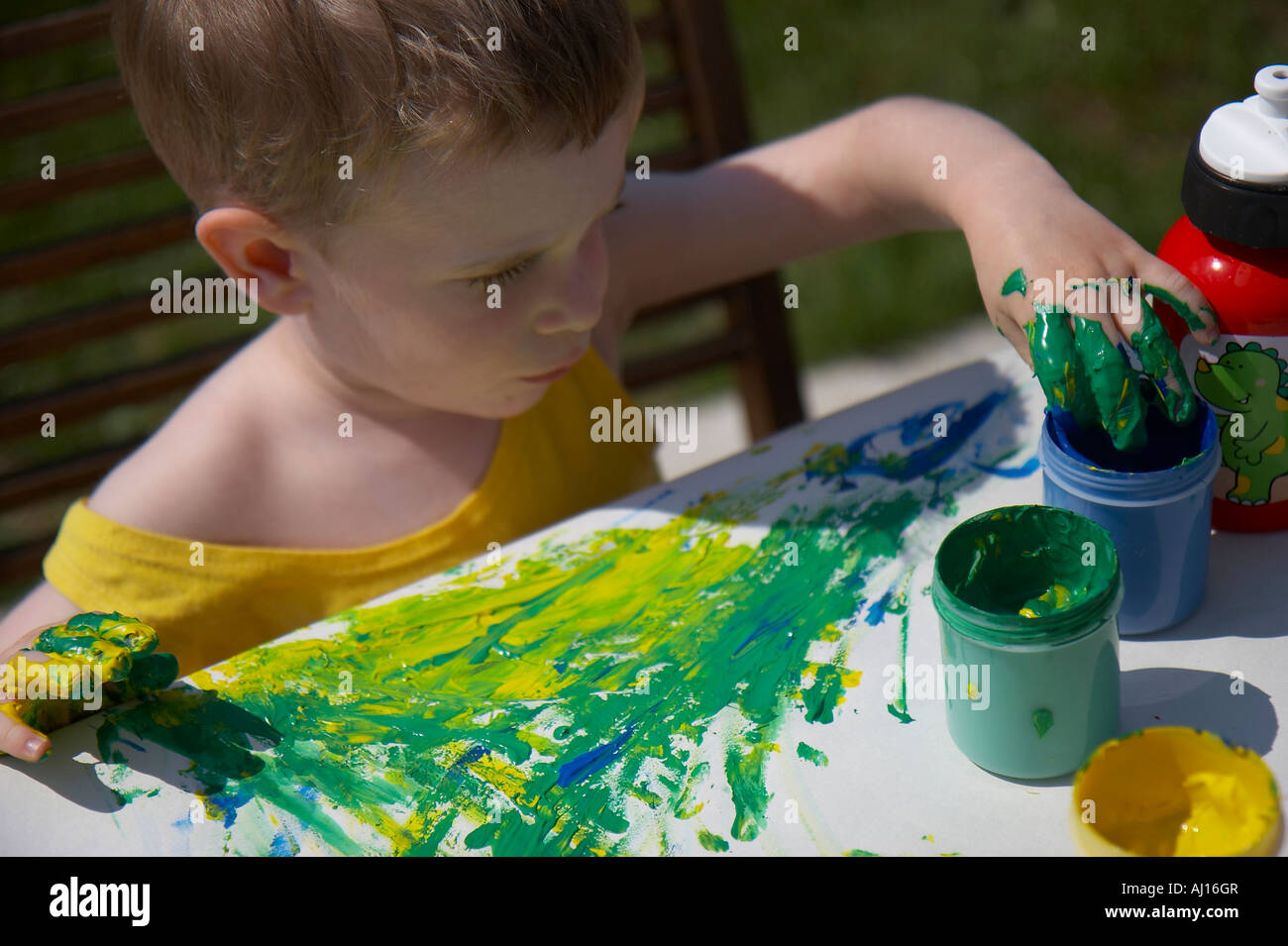 little boy painting with finger colours Stock Photo Alamy