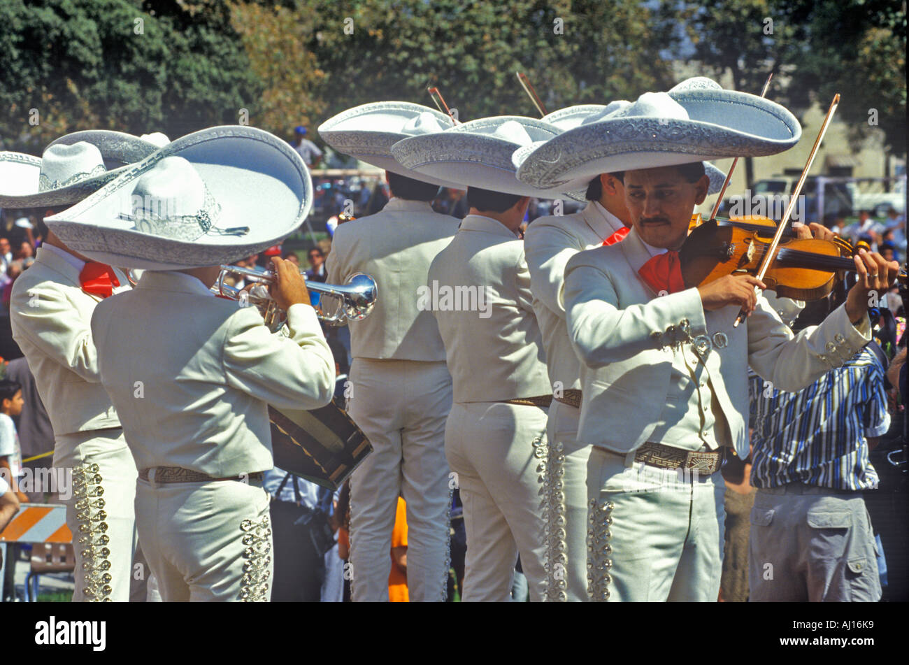 Traditional Mariachi band performing outside in white costumes Mexican Independence Day Baldwin Park CA Stock Photo