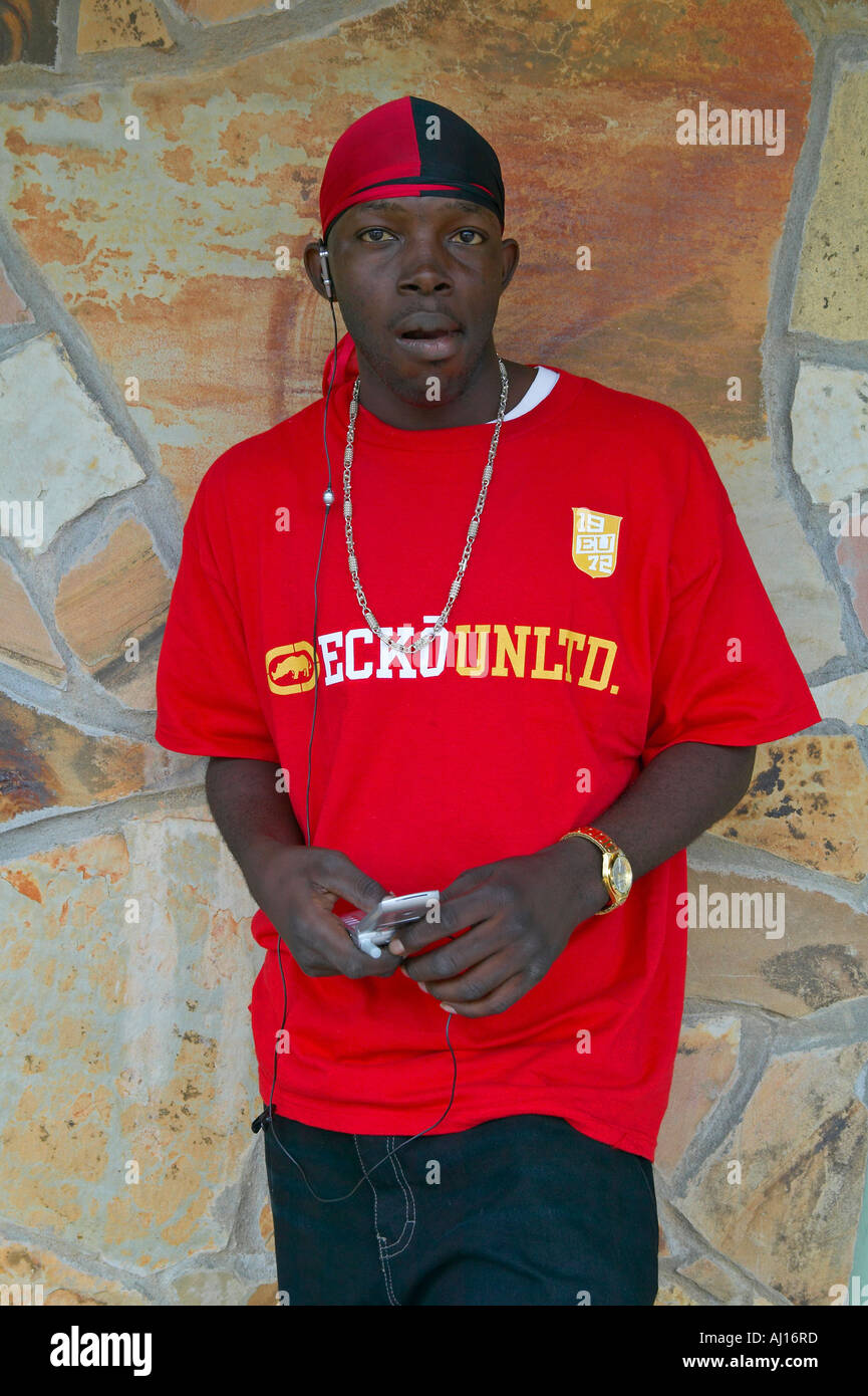 African American teenager with cell phone headphones and red shirt in Central Georgia Stock Photo