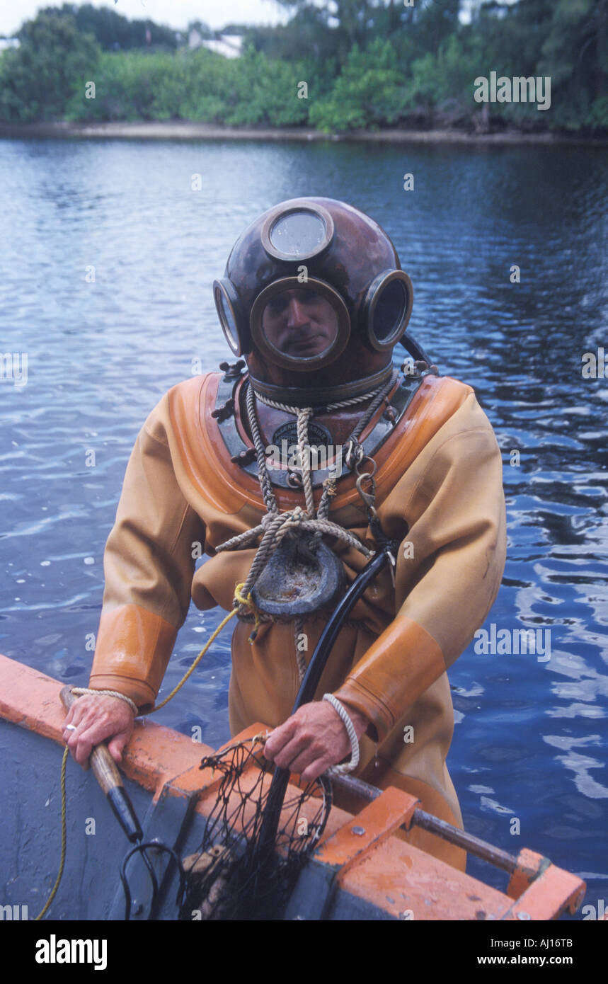 Historic Greek sponge diver in antique diving suit dives for sponges in